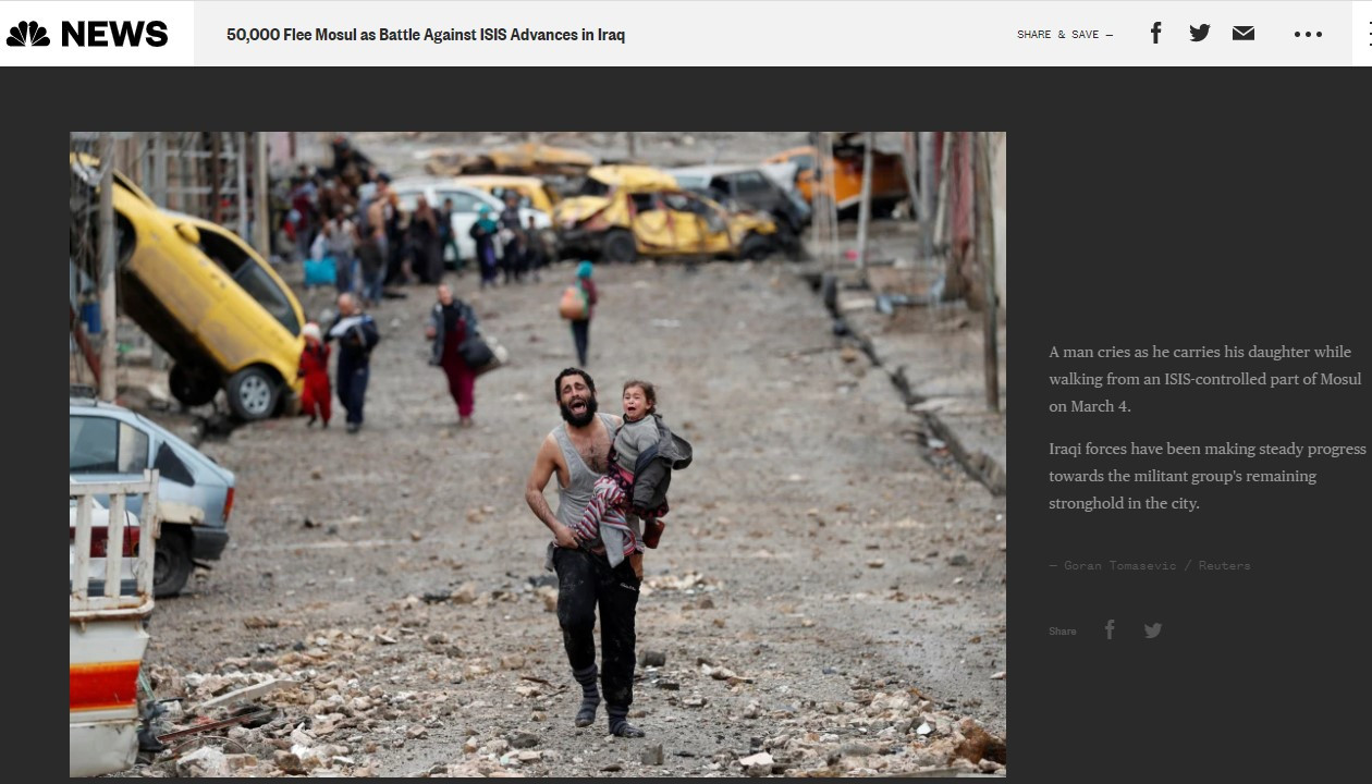 A man cries as he carries his daughter while walking from an ISIS-controlled part of Mosul on March 4
